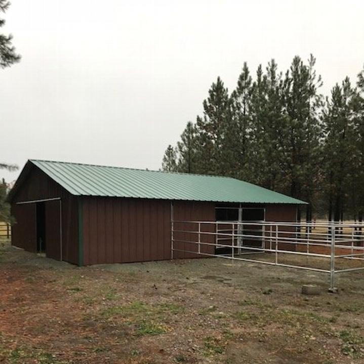 Metal Barn with pipe corral interior.